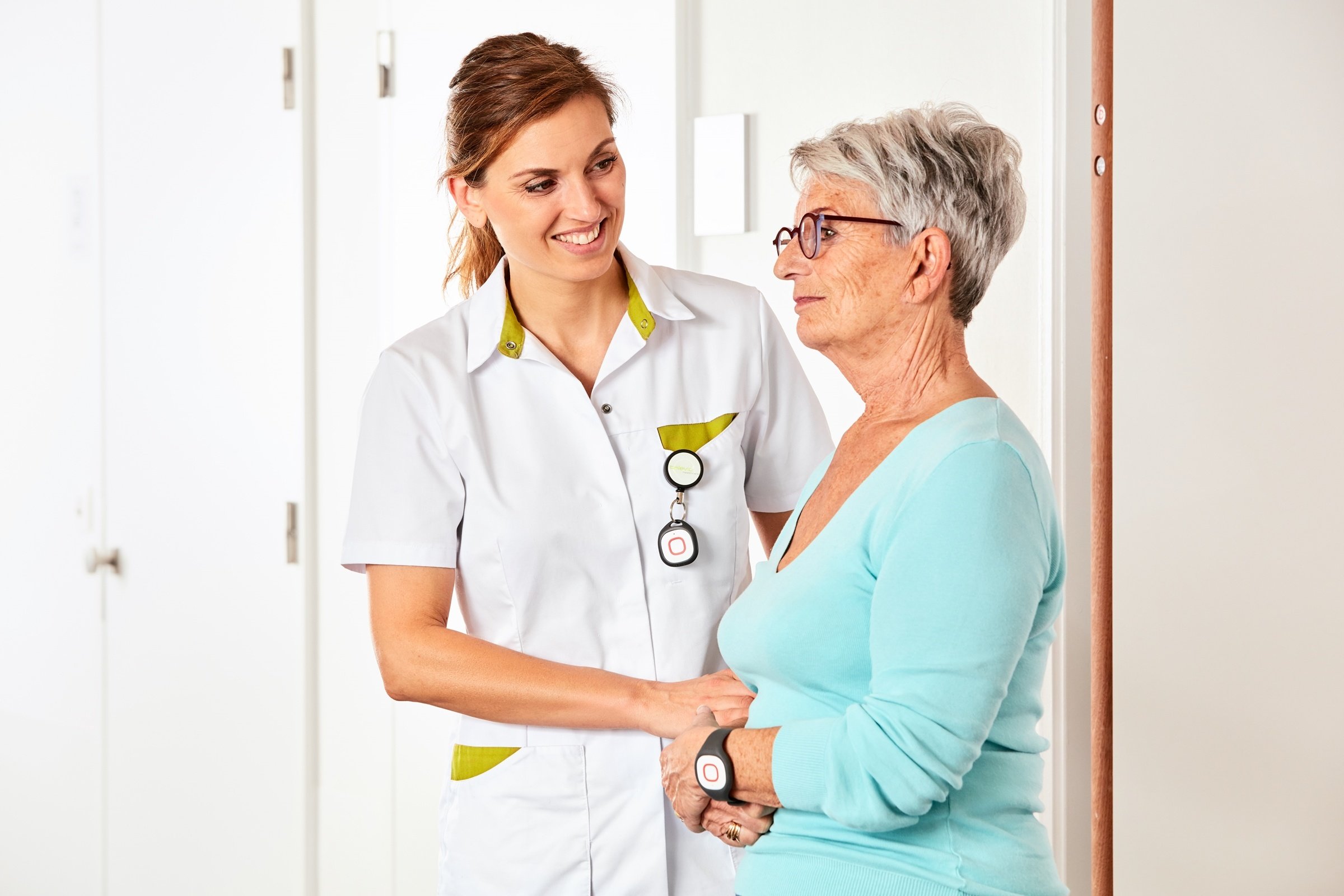 Nurse with resident wearing wearables for alarming